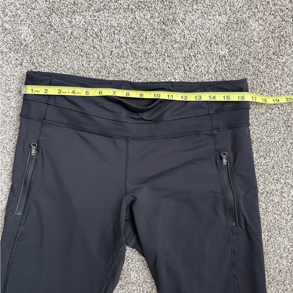Lululemon black athletic pants with zippered pockets and a tapered silhouette - Picture 3 of 5